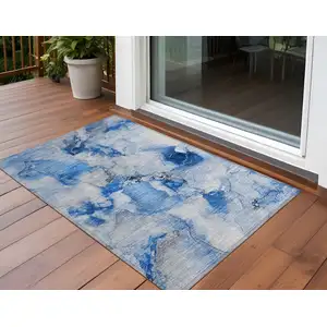 Photo of 3' X 5' Blue and Ivory Abstract Washable Non Skid Indoor Outdoor Area Rug