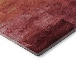 Photo of 8' X 8' Blush Orange And Pink Striped Washable Round Rug With UV Protection