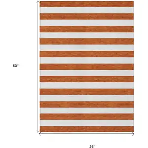 Photo of 3' X 5' Orange Striped Washable Non Skid Indoor Outdoor Area Rug