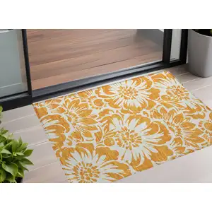 Photo of 3' X 5' Orange and White Floral Washable Non Skid Indoor Outdoor Area Rug