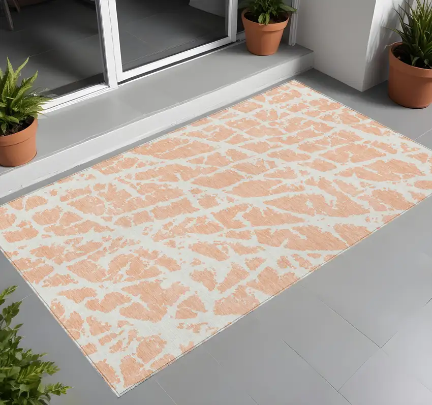 3' X 4' Peach and Ivory Abstract Washable Non Skid Indoor Outdoor Area Rug Photo 1