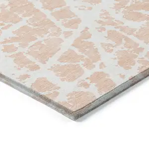 Photo of 3' X 5' Peach and Ivory Abstract Washable Non Skid Indoor Outdoor Area Rug