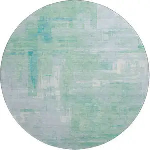Photo of 8' X 8' Sky Blue Ivory And Teal Abstract Washable Round Rug With UV Protection