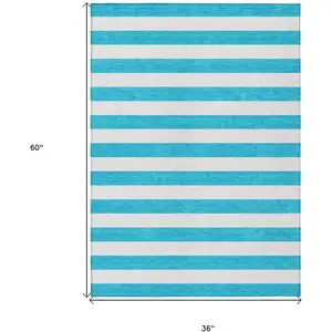 Photo of 3' X 5' Teal Striped Washable Non Skid Indoor Outdoor Area Rug