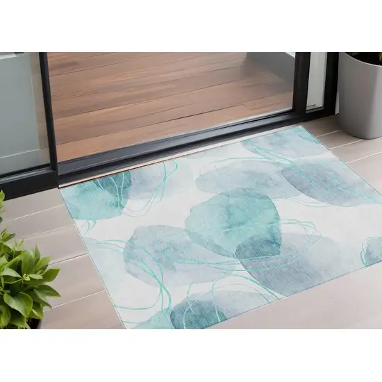 Teal and Ivory Abstract Washable Non Skid Indoor Outdoor Area Rug Photo 1