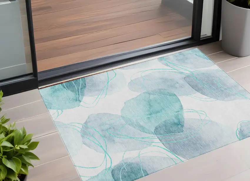 Teal and Ivory Abstract Washable Non Skid Indoor Outdoor Area Rug Photo 1