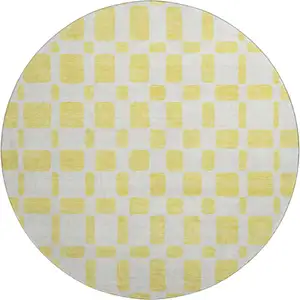 Photo of 8' Yellow And Beige Geometric Washable Round Rug With UV Protection