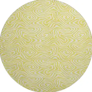 Photo of 8' Yellow And Ivory Abstract Washable Round Rug With UV Protection