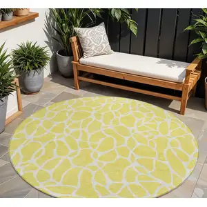 Photo of 8' Yellow And Ivory Round Geometric Washable Indoor Outdoor Area Rug