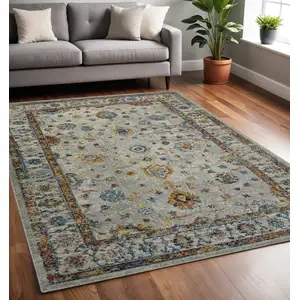 Photo of 5' x 7' Orange and Ivory Floral Power Loom Area Rug