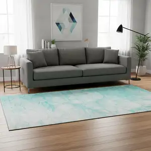 Photo of Aqua And Ivory Abstract Washable Area Rug With UV Protection