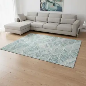 Photo of Aqua And Ivory Geometric Washable Area Rug With UV Protection