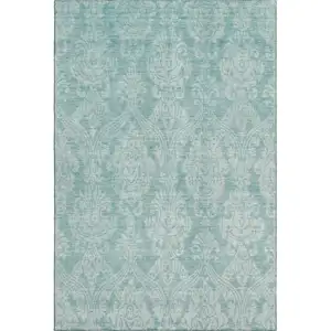Photo of Aqua Teal And Ivory Damask Washable Area Rug With UV Protection