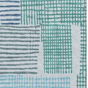 Photo of Aqua Teal And Ivory Geometric Washable Area Rug With UV Protection