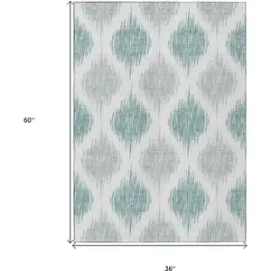 Photo of Aqua Teal Blue And Ivory Ikat Washable Indoor Outdoor Area Rug