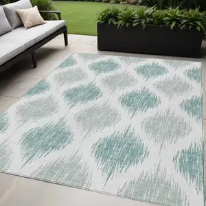Photo of Aqua Teal Blue And Ivory Ikat Washable Indoor Outdoor Area Rug