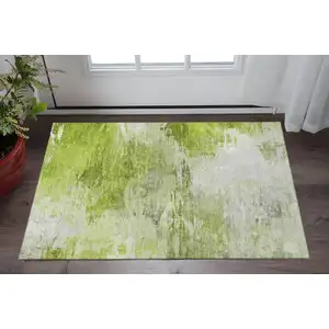 Photo of Artichoke Green And Ivory Abstract Washable Area Rug With UV Protection