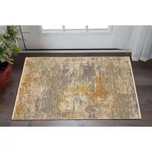 Photo of Beige And Gold Abstract Area Rug With Fringe