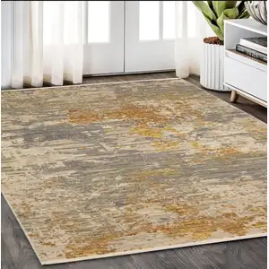 Photo of Beige And Gold Abstract Area Rug With Fringe