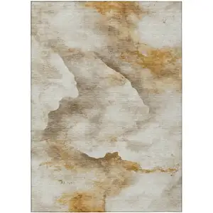 Photo of Beige And Gold Abstract Washable Indoor Outdoor Area Rug