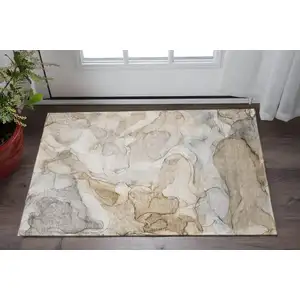 Photo of Beige And Ivory Abstract Washable Area Rug With UV Protection
