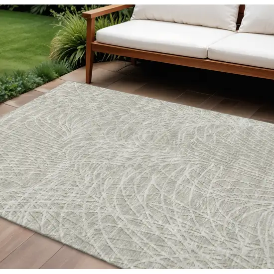 Beige And Ivory Abstract Washable Indoor Outdoor Area Rug Photo 1