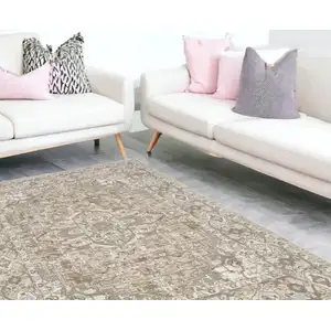 Photo of Beige And Ivory Floral Distressed Area Rug