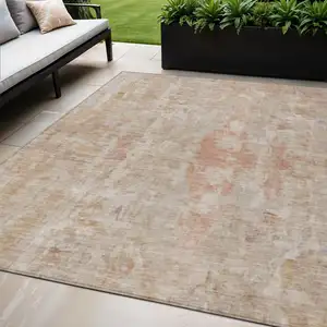 Photo of Beige And Salmon Abstract Washable Indoor Outdoor Area Rug