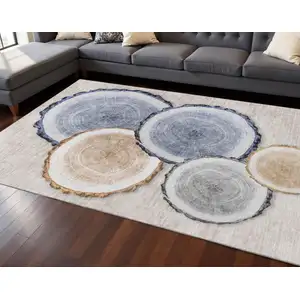 Photo of Beige Blue And Ivory Woodland Lodge Washable Area Rug With UV Protection