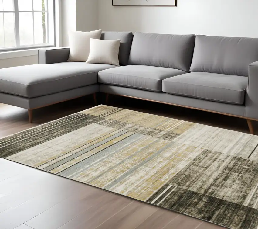 6' X 9' Beige Charcoal Brown Grey Tan Gold And Blue Geometric Power Loom Stain Resistant Area Rug With Fringe Photo 1