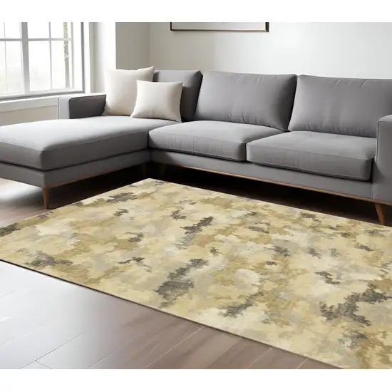 6' X 9' Beige Grey And Gold Abstract Power Loom Stain Resistant Area Rug Photo 1