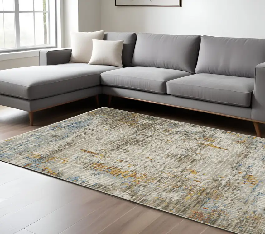 6' X 9' Beige Grey Brown Gold Red And Blue Abstract Power Loom Stain Resistant Area Rug With Fringe Photo 1