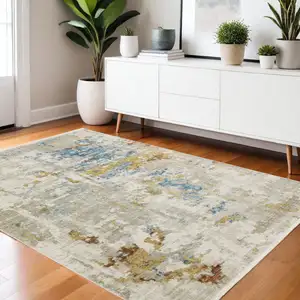 Photo of Beige Grey Gold Blue Rust And Teal Abstract Power Loom Stain Resistant Area Rug With Fringe
