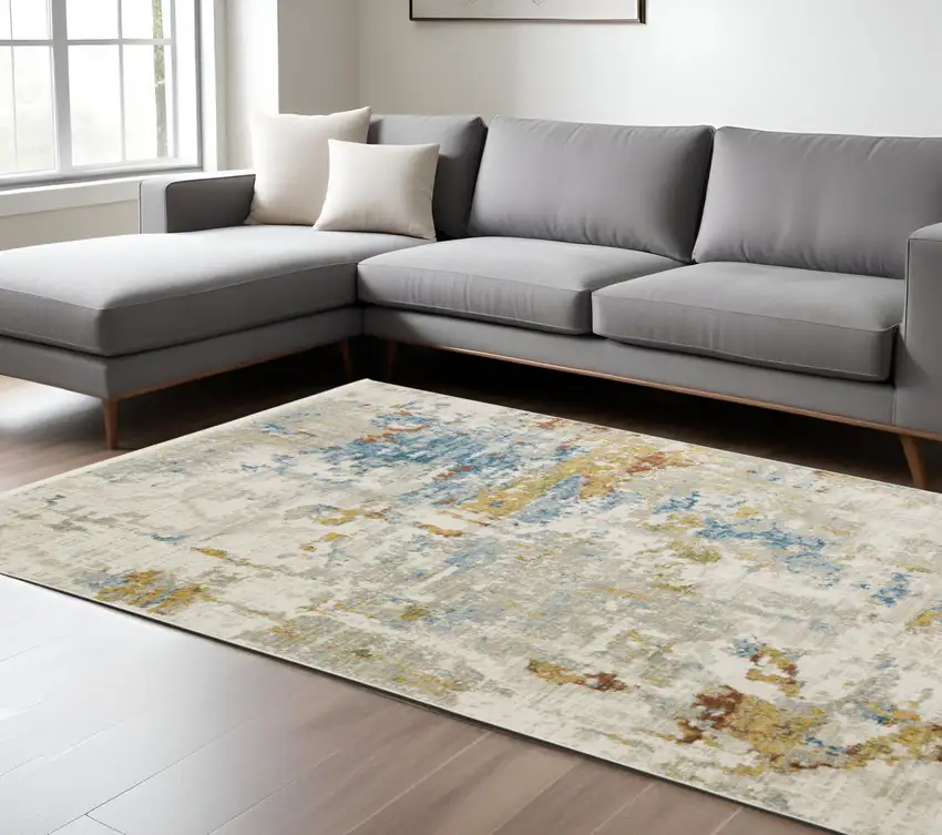 6' X 9' Beige Grey Gold Blue Rust And Teal Abstract Power Loom Stain Resistant Area Rug With Fringe Photo 1