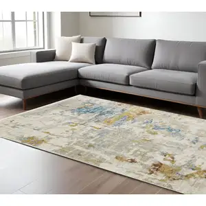 Photo of Beige Grey Gold Blue Rust And Teal Abstract Power Loom Stain Resistant Area Rug With Fringe