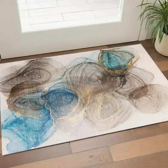 Beige Ivory And Blue Abstract Washable Area Rug With UV Protection Photo 1