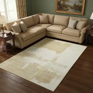 Photo of Beige Ivory And Gold Abstract Washable Area Rug With UV Protection