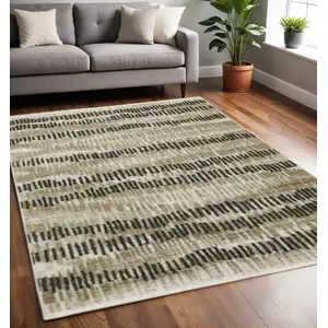 Photo of Beige Ivory Charcoal Brown Tan And Grey Abstract Power Loom Stain Resistant Area Rug With Fringe