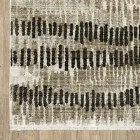 Photo of Beige Ivory Charcoal Brown Tan And Grey Abstract Power Loom Stain Resistant Area Rug With Fringe