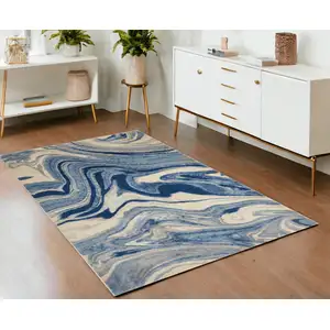 Photo of Beige Navy Blue And Light Blue Abstract Non Skid Area Rug