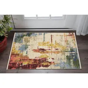 Photo of Beige Orange And Red Abstract Area Rug With Fringe