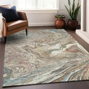 Photo of Beige Pink And Blue Abstract Washable Indoor Outdoor Area Rug