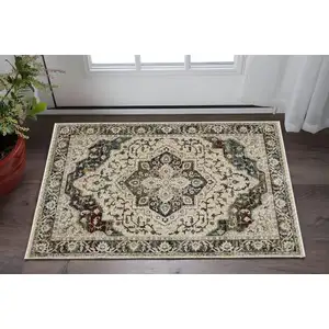 Photo of Beige Rust And Blue Medallion Area Rug With Fringe
