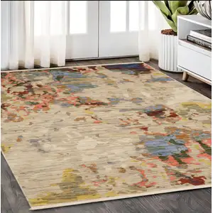 Photo of Beige Tan And Light Blue Abstract Area Rug With Fringe