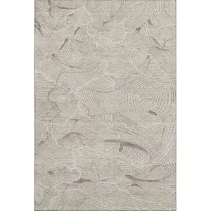 Photo of Beige Taupe And Ivory Abstract Washable Area Rug With UV Protection