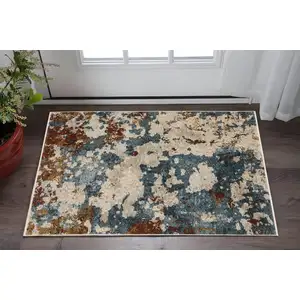 Photo of Beige Teal And Rust Abstract Area Rug With Fringe