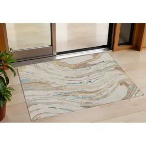 Photo of Beige Teal Blue And Ivory Abstract Washable Indoor Outdoor Area Rug