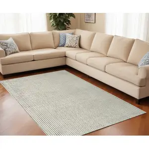 Photo of Beige and Black Checkered Power Loom Distressed Area Rug