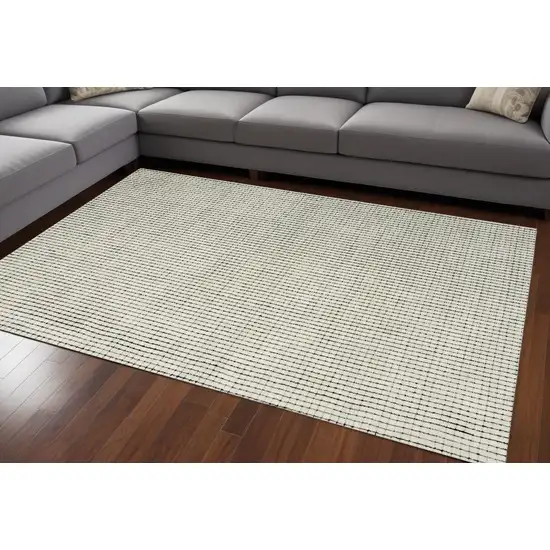 Beige and Black Checkered Power Loom Distressed Area Rug Photo 1
