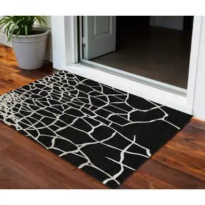 Photo of Black And Beige Abstract Washable Indoor Outdoor Area Rug